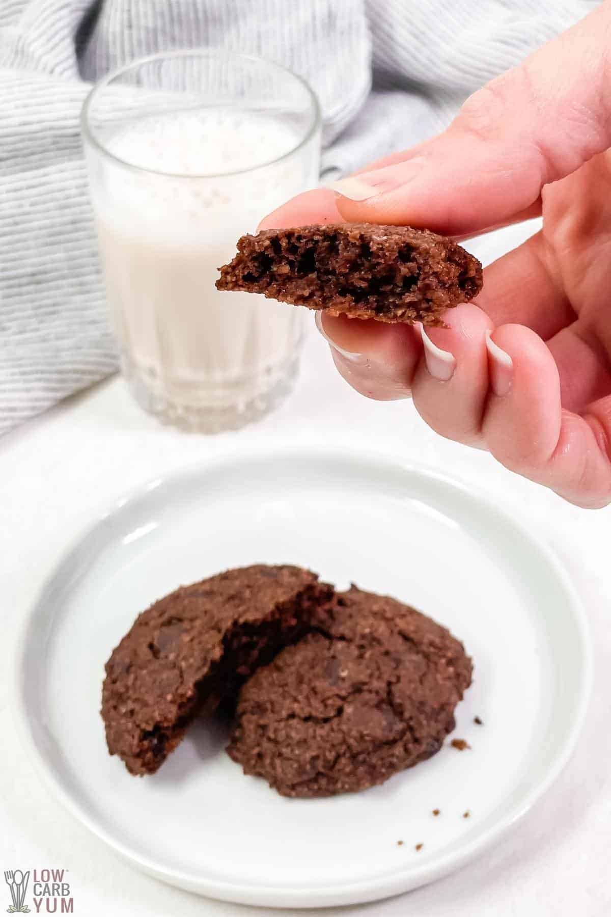 broken cookie on plate and in hand.